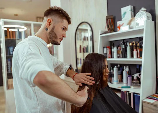 مرد آرایشگر در حال مرتب کردن مشتری خانم 